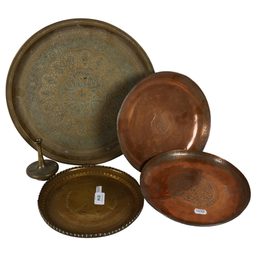 614 - A signed engraved copper dish, and another, and 2 Eastern engraved brass dishes, largest 35cm