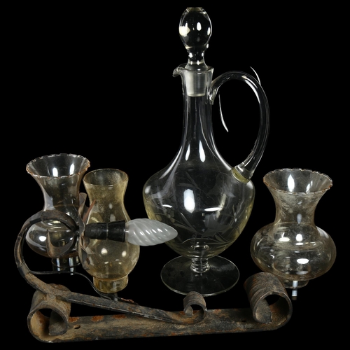 631 - Antique glass wine jug on plinth with stopper, H40cm, a wrought-iron wall light with shade etc