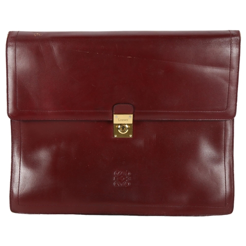 633 - A Loewe leather briefcase, with brass mounts and carrying strap, 37.5cm across