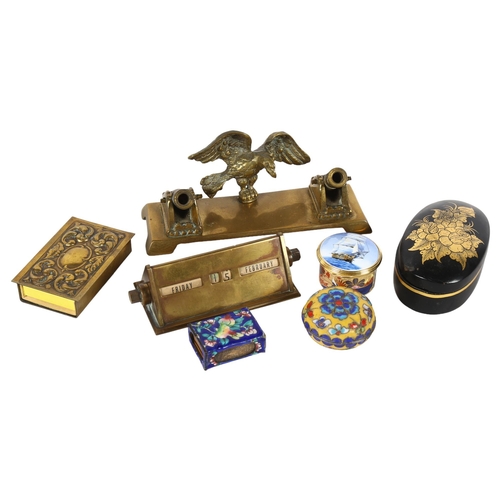 639 - A brass perpetual calendar, a desk stand surmounted by eagle and cannons, L17cm, matchbox holders et... 