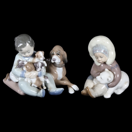 652 - A Lladro group, boy with dog and puppies, H12.5cm, and a Lladro Daisa Inuit child with bear