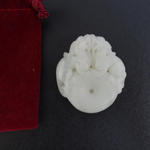 108 - 4 various Chinese carved jade pendants, all with carved and relief decoration, tallest 7cm