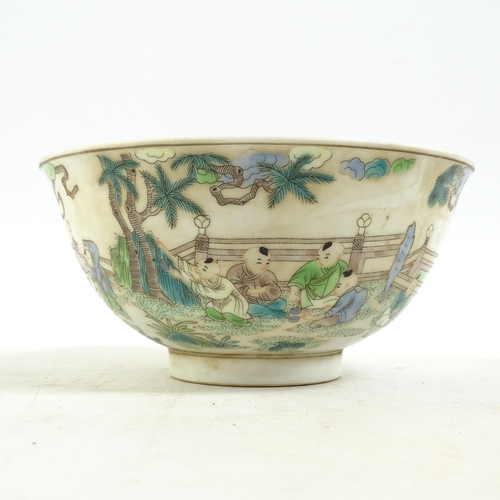 186 - A Chinese famille verte bowl on foot, with painted village figure decoration, and a blue six charact... 