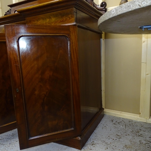 2524 - A Victorian mahogany inverted break front sideboard, with raised carved back and panelled cupboards ... 