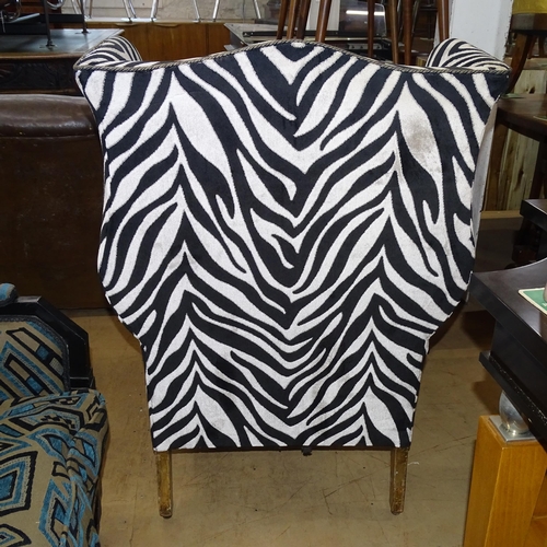 2177 - A Victorian wingback armchair with Zebra style upholstery.