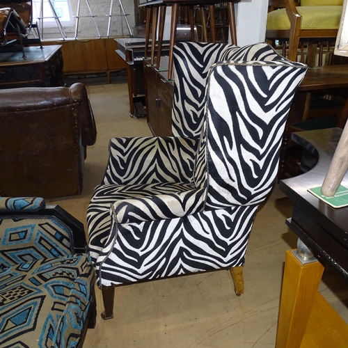 2177 - A Victorian wingback armchair with Zebra style upholstery.