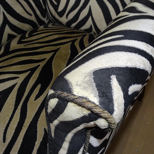 2177 - A Victorian wingback armchair with Zebra style upholstery.