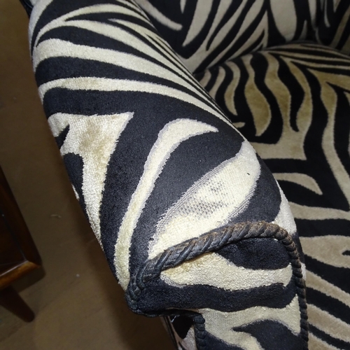 2177 - A Victorian wingback armchair with Zebra style upholstery.