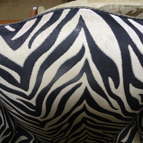 2177 - A Victorian wingback armchair with Zebra style upholstery.