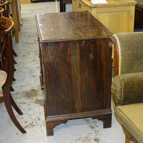 2539 - A Georgian oak kneehole writing desk, with seven drawers and cupboard, raised on bracket feet. 92x80... 