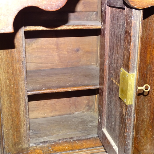 2539 - A Georgian oak kneehole writing desk, with seven drawers and cupboard, raised on bracket feet. 92x80... 