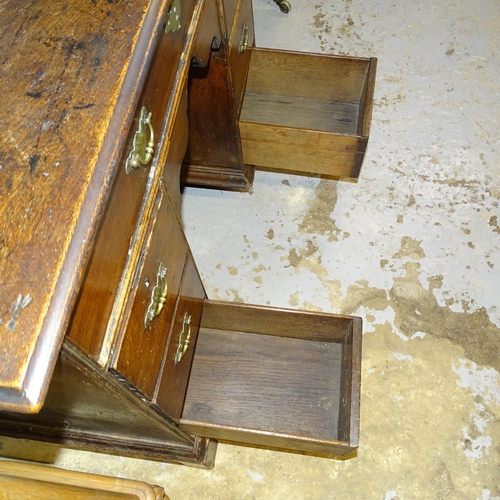 2539 - A Georgian oak kneehole writing desk, with seven drawers and cupboard, raised on bracket feet. 92x80... 