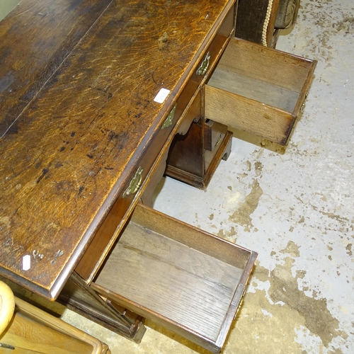 2539 - A Georgian oak kneehole writing desk, with seven drawers and cupboard, raised on bracket feet. 92x80... 