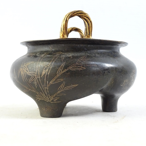 101 - A Chinese bronze 2-handled censer, with gilded bamboo and blossom decoration, on 3 feet, width 12cm,... 