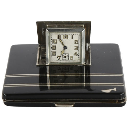 11 - An Art Deco compact / travel clock, in black lacquer and silver plate detail, 7.5cm sq
