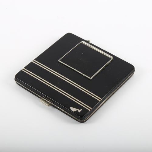 11 - An Art Deco compact / travel clock, in black lacquer and silver plate detail, 7.5cm sq