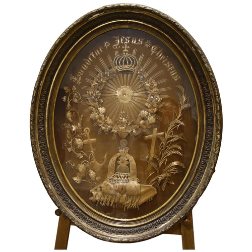 15 - An 18th/19th century large French straw-work 
Reliquary in large gesso oval gilt frame, overall heig... 