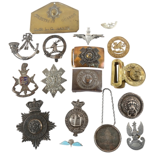 29 - Military Interest - A collection of Victorian and later British military badges, buckles and locker ... 