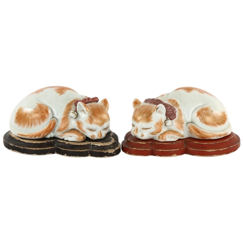 3 - 2 similar Japanese, Meiji period, sleeping porcelain cats, on original wooden stands, longest 17.5cm