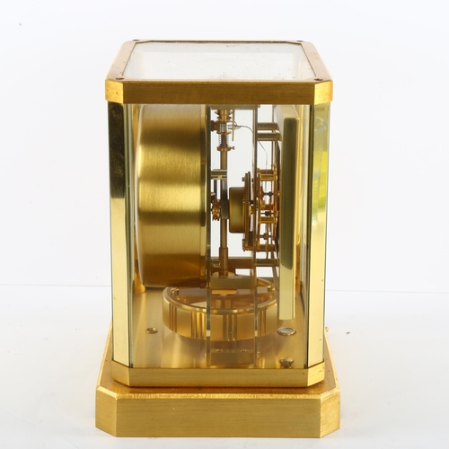 103 - JAEGER LECOULTRE - a gilt-brass Atmos clock, square white lacquered dial with quarterly Arabic numer... 