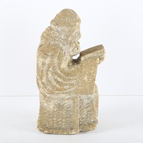 114 - A Ecclesiastic stone carving of a monk reading a Bible, height 14cm