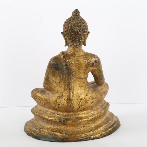 115 - A gilded cast-metal figure of a Buddha, height 23cm