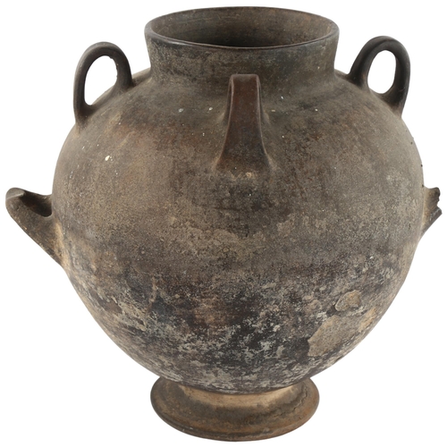 122 - A North African lugged vessel on footed base, height 30cm