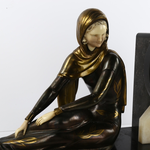 60 - An Art Deco clock on marble base with bronzed and gilded metal figure, length 50cm