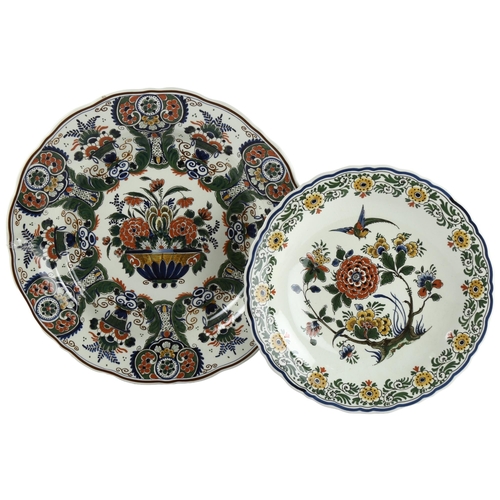 62 - 2 Delft wall-hung plates with floral decoration, largest diameter 37.5cm