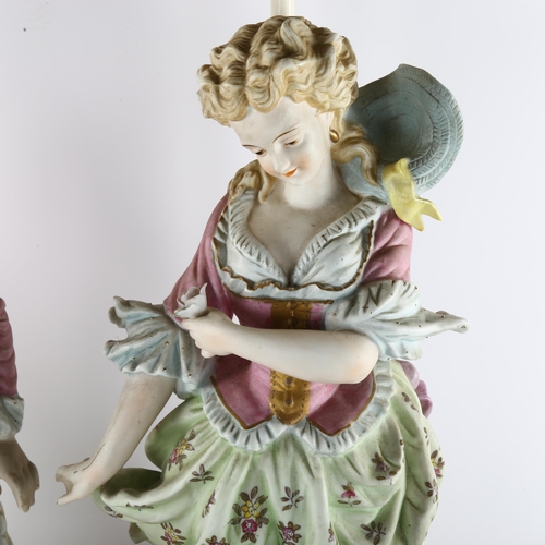 63 - A pair of large Continental porcelain figures on lamp base of pierced metal, height of figures and b... 