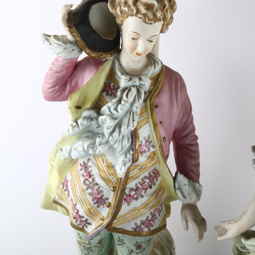 63 - A pair of large Continental porcelain figures on lamp base of pierced metal, height of figures and b... 