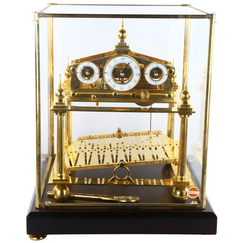 65 - A 20th century brass Congreve clock, with rolling ball fusee movement housed in glass display cabine... 