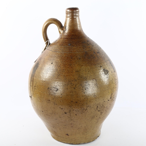 66 - A large 18th Century salt glaze Bellarmine jug, height 44cm