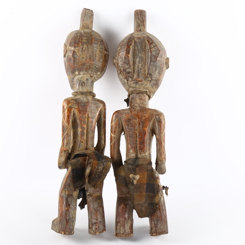 67 - A pair of West African carved wood figures, tallest 44cm