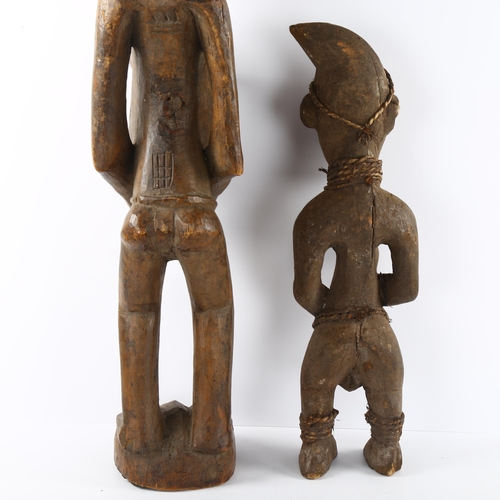 68 - Two African carved wood figures, small figure has rope and shell detail, tallest 74cm