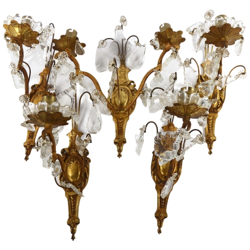 74 - A set of mid-20th century crystal hung gilded brass wall sconces, comprising 4 single light and 1 do... 