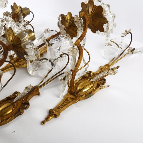 74 - A set of mid-20th century crystal hung gilded brass wall sconces, comprising 4 single light and 1 do... 