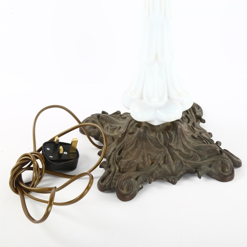 76 - An Art Nouveau milk glass Astral lamp, with cast metal base, height of lamp 90cm