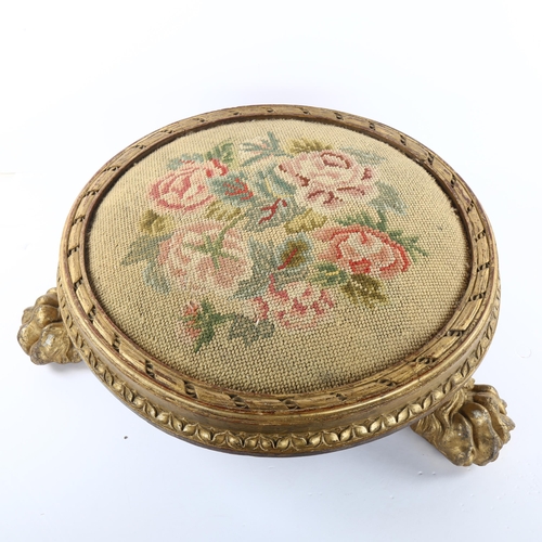 77 - A Georgian tapestry-topped footstool, with gilded wood surround and lion paw feet, diameter approx 4... 