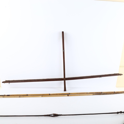 86 - A rosewood cross-bow, early 20th century, another bow, and 2 bamboo spears