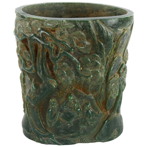 91 - A Chinese green hardstone relief carved brush pot, character marks to back and base, height 15.5cm