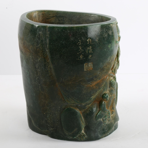 91 - A Chinese green hardstone relief carved brush pot, character marks to back and base, height 15.5cm