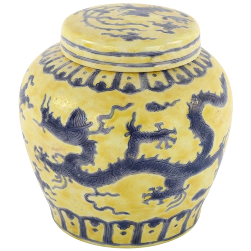 143 - A Chinese yellow ground porcelain jar and cover, with blue painted dragon designs, 6 character mark,... 