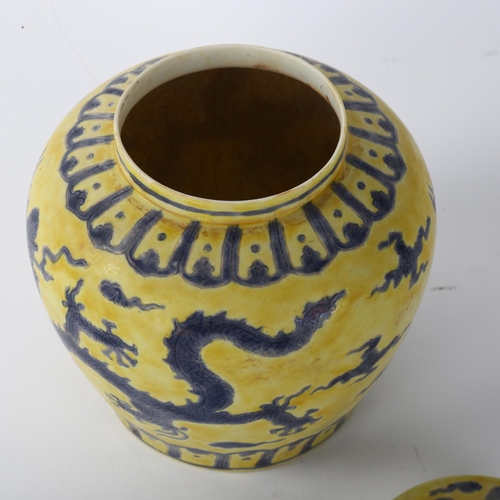 143 - A Chinese yellow ground porcelain jar and cover, with blue painted dragon designs, 6 character mark,... 