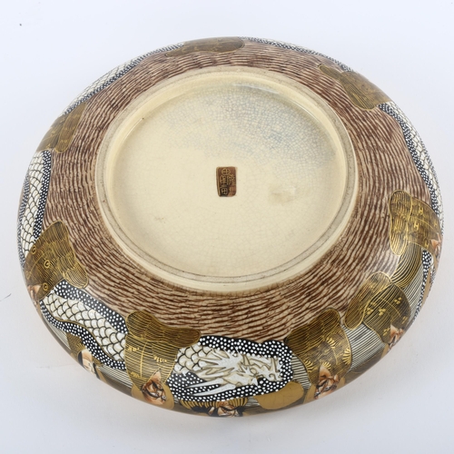 146 - A Japanese Satsuma porcelain bowl, with painted and gilded dragon and figures, diameter 21cm