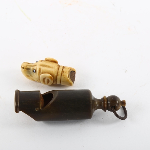 166 - An Antique bone dog's head whistle, and a turned horn whistle