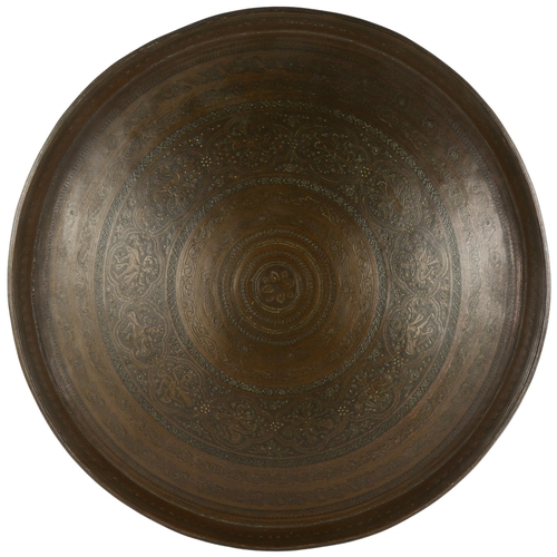 167 - A heavy Eastern brass tray with allover engraving, diameter 68cm