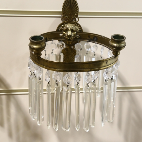 177 - A pair of early 20th century lion head wall sconces, with crystal lustre drops, overall height 29cm