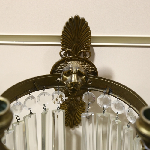 177 - A pair of early 20th century lion head wall sconces, with crystal lustre drops, overall height 29cm