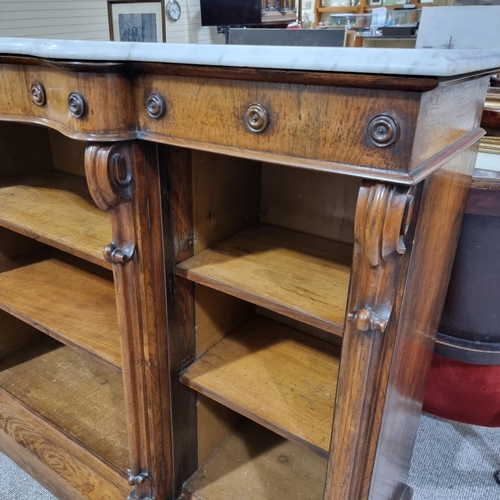 205 - A Victorian Rosewood open shelved and marble top bookcase, with serpentine breakfront and carved scr... 